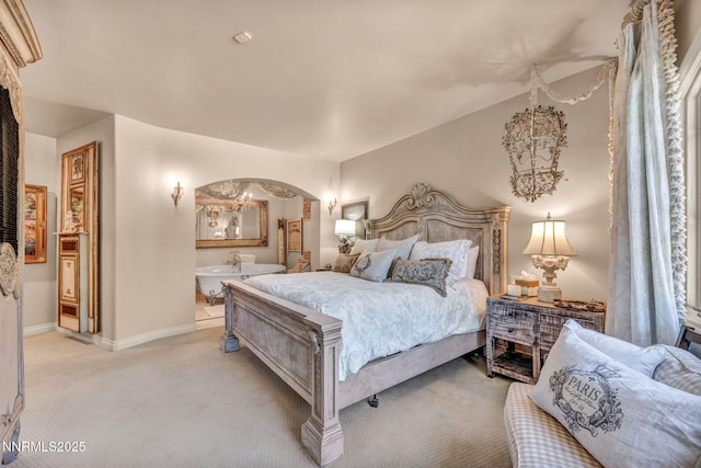 3820 Frost Ln, Reno, NV 89511 - bedroom featuring light colored carpet, arched walkways, and ensuite bath