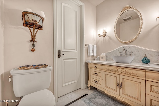 3820 Frost Ln, Reno, NV 89511 - bathroom featuring marble look tiles and vanity
