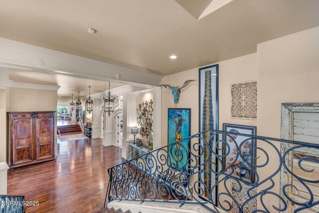 3820 Frost Ln, Reno, NV 89511 - corridor featuring wood finished floors, ornamental molding, a chandelier, and recessed lighting