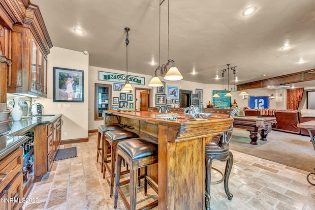 3820 Frost Ln, Reno, NV 89511 - kitchen featuring billiards table, a breakfast bar, recessed lighting, glass insert cabinets, and brown cabinetry