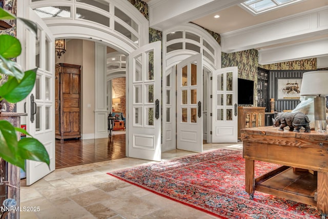 3820 Frost Ln, Reno, NV 89511 - entryway with arched walkways, stone finish flooring, ornamental molding, and recessed lighting