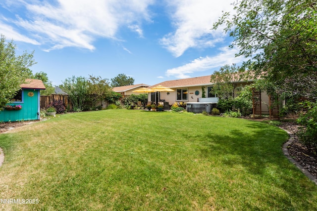 644 Carmel Way, Gardnerville, NV 89460 - fenced backyard featuring a hot tub and an outdoor structure