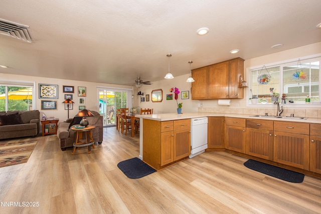 644 Carmel Way, Gardnerville, NV 89460 - kitchen featuring white dishwasher, open floor plan, a peninsula, light wood-style floors, and light countertops