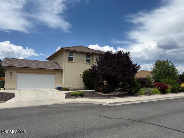 1108 Tuscan Ct, Minden, NV 89423 - view of front facade with an attached garage, concrete driveway, and stucco siding
