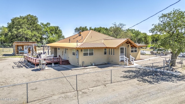 4525 Schurz Hwy, Fallon, NV 89406 - back of house featuring stucco siding, a wooden deck, and a metal roof