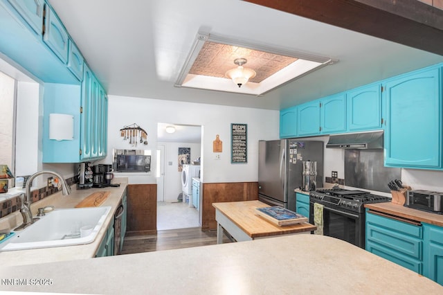 4525 Schurz Hwy, Fallon, NV 89406 - kitchen featuring stainless steel appliances, blue cabinets, and wainscoting