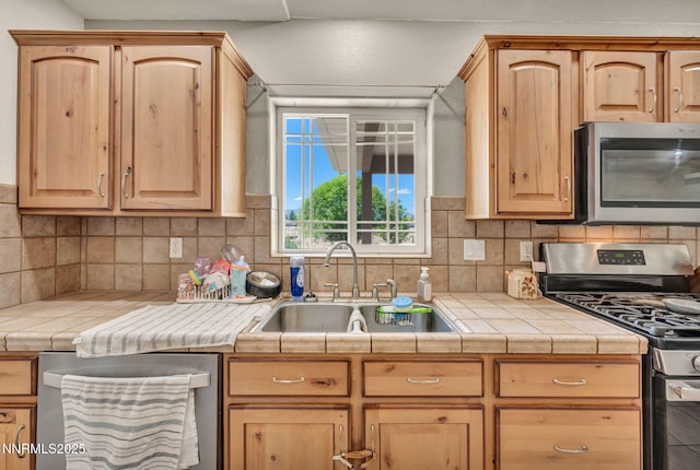 8030 Verde Ct, Winnemucca, NV 89445 - kitchen featuring stainless steel appliances, light brown cabinets, and tasteful backsplash