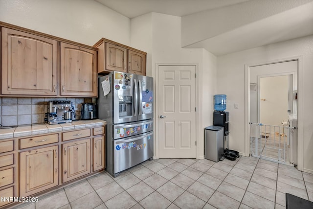 8030 Verde Ct, Winnemucca, NV 89445 - kitchen featuring stainless steel fridge, tile countertops, decorative backsplash, and light tile patterned floors