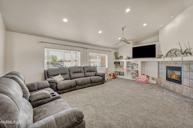 8030 Verde Ct, Winnemucca, NV 89445 - living area with carpet, vaulted ceiling, a tiled fireplace, a ceiling fan, and recessed lighting