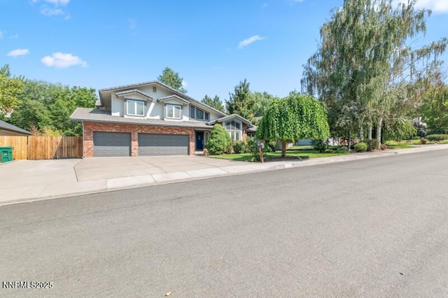 2126 Thomas Jefferson Dr, Reno, NV 89509 - view of front of home with a garage, driveway, and brick siding