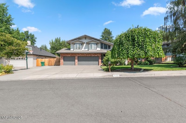 2126 Thomas Jefferson Dr, Reno, NV 89509 - view of front of property featuring concrete driveway, an attached garage, and brick siding