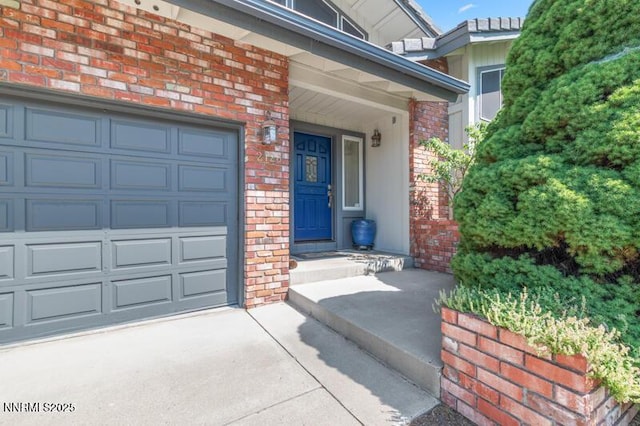 2126 Thomas Jefferson Dr, Reno, NV 89509 - property entrance featuring a garage, brick siding, and driveway