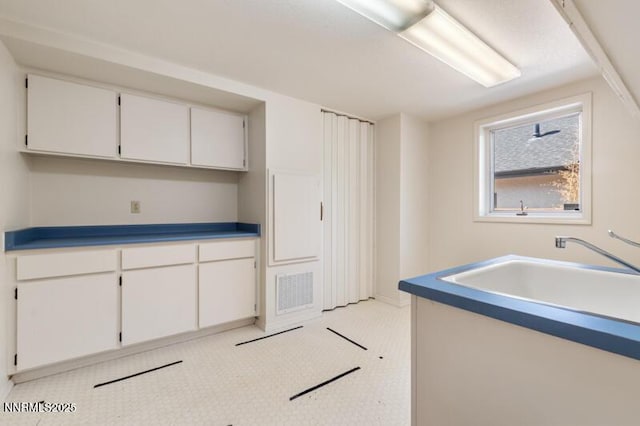 2126 Thomas Jefferson Dr, Reno, NV 89509 - kitchen with white cabinetry and baseboards