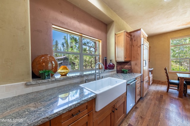 48 Rose Creek Ln, Reno, NV 89511 - kitchen with stainless steel dishwasher, wood finished floors, stone counters, and brown cabinets