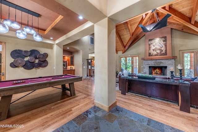 48 Rose Creek Ln, Reno, NV 89511 - rec room featuring billiards, a stone fireplace, a wooden ceiling with exposed beams, wood finished floors, and high vaulted ceiling