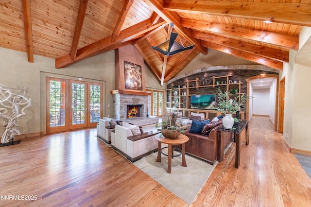 48 Rose Creek Ln, Reno, NV 89511 - living area with wood finished floors, a wooden ceiling with exposed beams, healthy amount of natural light, arched walkways, and a stone fireplace