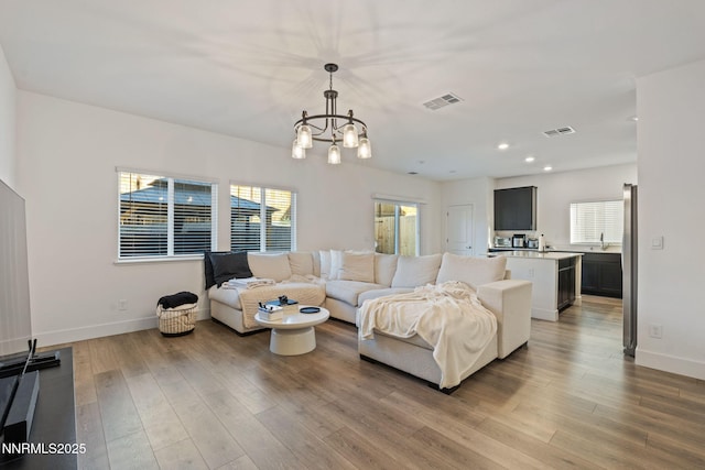 1413 Solitude Trl, Reno, NV 89523 - living room with light wood-style flooring, a chandelier, and recessed lighting