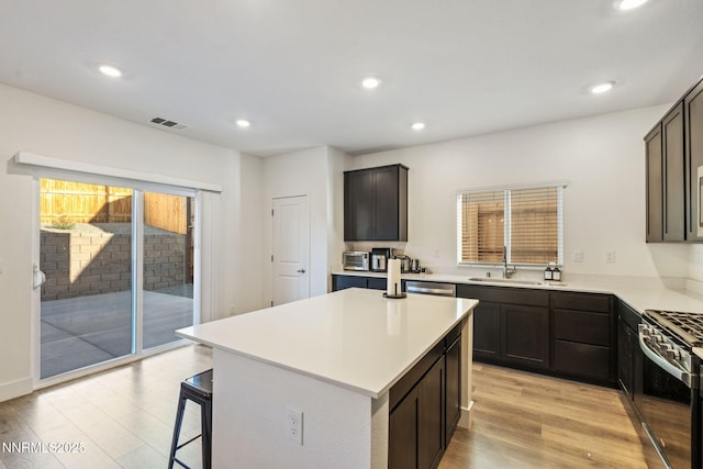 1413 Solitude Trl, Reno, NV 89523 - kitchen featuring appliances with stainless steel finishes, healthy amount of natural light, light wood finished floors, light countertops, and recessed lighting
