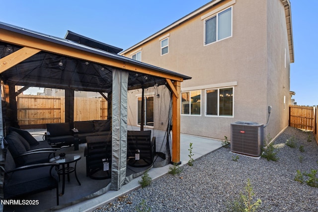 1413 Solitude Trl, Reno, NV 89523 - back of property with a gazebo, stucco siding, a patio area, a fenced backyard, and an outdoor living space