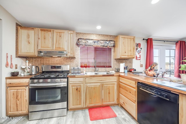 6297 Cox Rd, Fallon, NV 89406 - kitchen featuring black dishwasher, light brown cabinetry, stainless steel range with gas cooktop, under cabinet range hood, and backsplash
