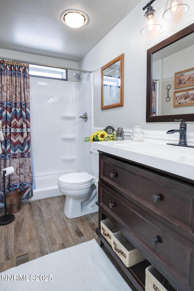 6297 Cox Rd, Fallon, NV 89406 - full bath featuring vanity, wood finished floors, and a shower with curtain