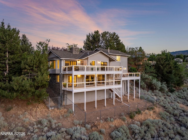 3575 Cashill Blvd, Reno, NV 89509 - rear view of property with a chimney, a wooden deck, and stairs