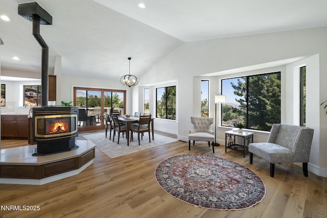 3575 Cashill Blvd, Reno, NV 89509 - living area featuring a wood stove, vaulted ceiling, light wood-style flooring, a chandelier, and recessed lighting