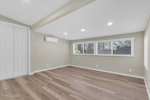 1094 Johnson Blvd, South Lake Tahoe, CA 96150 - unfurnished bedroom featuring wood finished floors, recessed lighting, a wall mounted air conditioner, and a closet