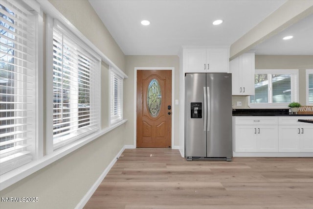 1094 Johnson Blvd, South Lake Tahoe, CA 96150 - kitchen featuring stainless steel fridge with ice dispenser, light wood finished floors, white cabinets, recessed lighting, and dark countertops