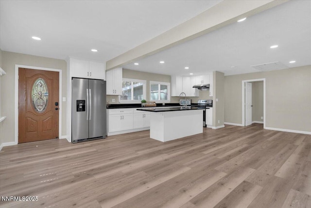 1094 Johnson Blvd, South Lake Tahoe, CA 96150 - kitchen featuring appliances with stainless steel finishes, under cabinet range hood, white cabinetry, dark countertops, and recessed lighting