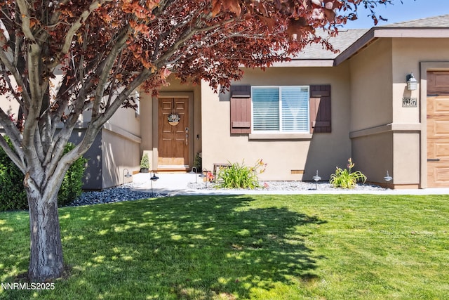 3287 Hackamore Way, Winnemucca, NV 89445 - view of exterior entry with stucco siding and a yard