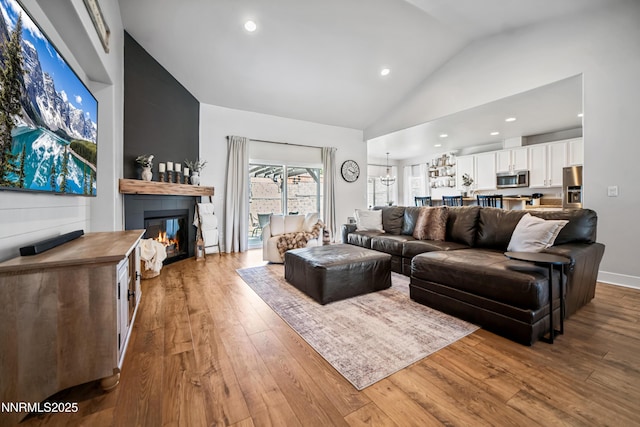 3287 Hackamore Way, Winnemucca, NV 89445 - living room featuring a glass covered fireplace, hardwood / wood-style flooring, high vaulted ceiling, and recessed lighting