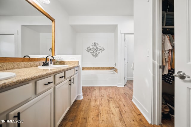 3287 Hackamore Way, Winnemucca, NV 89445 - full bath with a garden tub, double vanity, a walk in closet, wood finished floors, and a shower