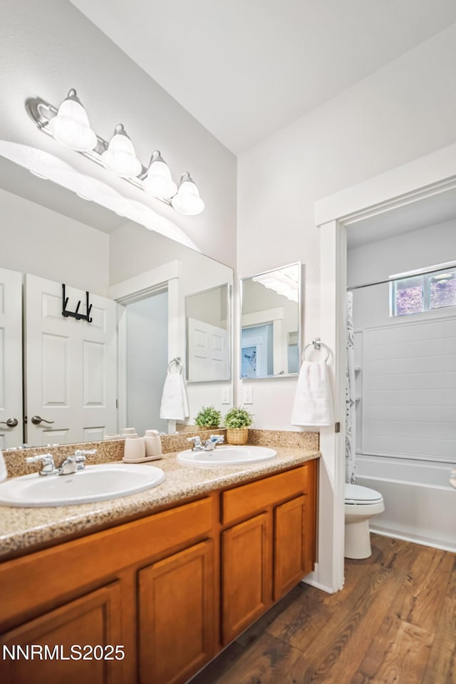 3287 Hackamore Way, Winnemucca, NV 89445 - full bathroom with double vanity, wood finished floors, and shower / tub combination