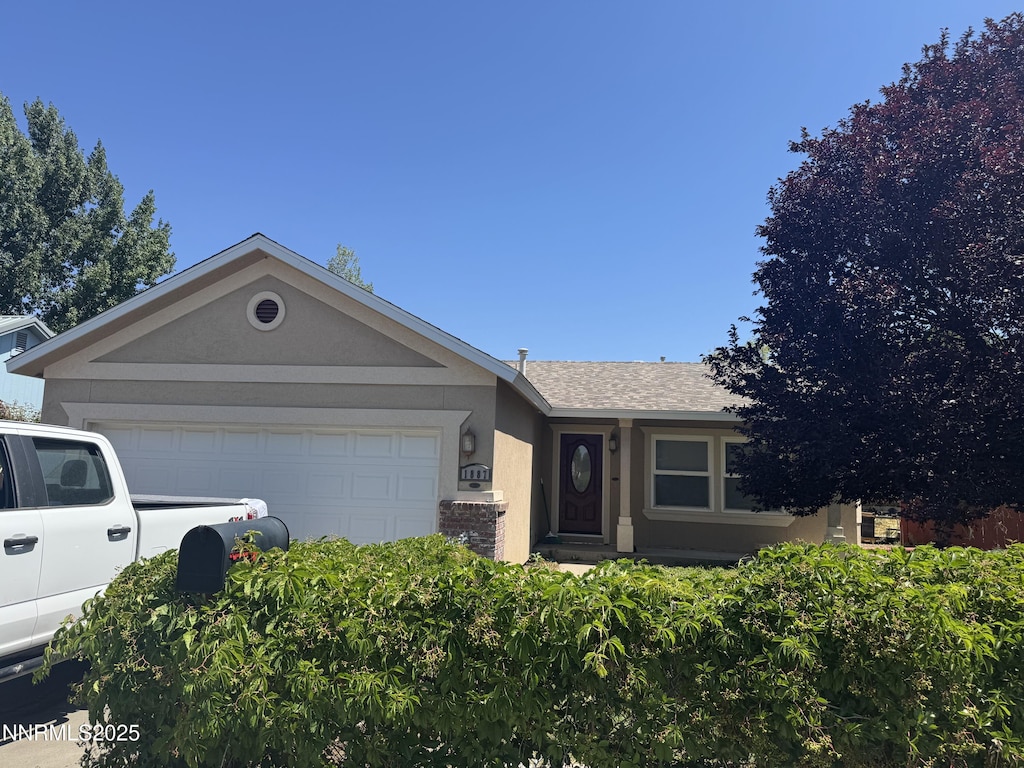 1887 Scott St, Winnemucca, NV 89445 - ranch-style home with a garage, stucco siding, and a shingled roof