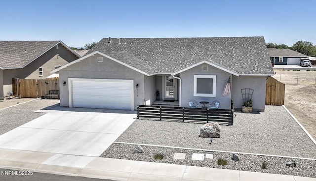 776 Kinsli St, Fallon, NV 89406 - view of front of home featuring a garage, concrete driveway, stucco siding, and roof with shingles