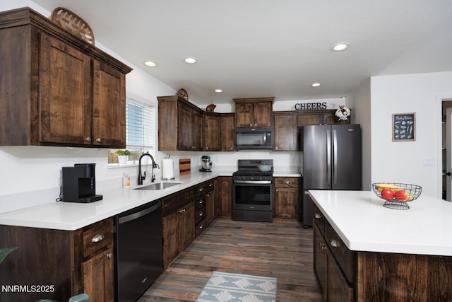 776 Kinsli St, Fallon, NV 89406 - kitchen with black microwave, dishwashing machine, gas stove, freestanding refrigerator, and dark wood-style flooring