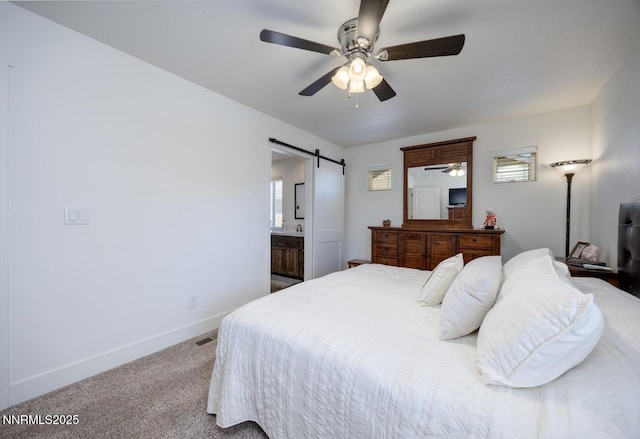 776 Kinsli St, Fallon, NV 89406 - bedroom featuring a barn door, carpet flooring, a ceiling fan, and ensuite bath