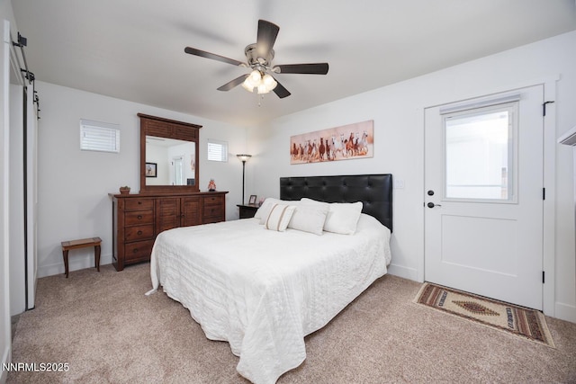 776 Kinsli St, Fallon, NV 89406 - bedroom with light colored carpet, a barn door, and a ceiling fan