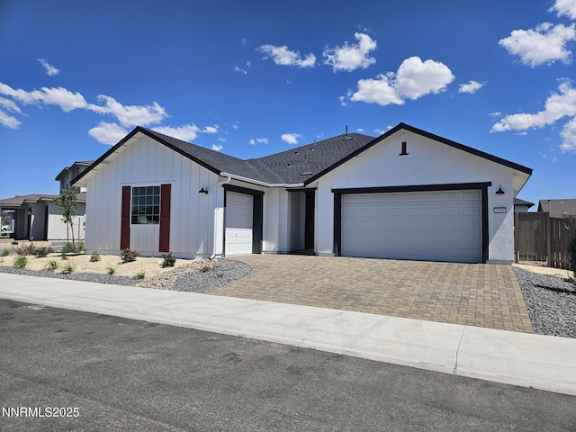 1205 Spur Way, Gardnerville, NV 89410 - view of front of property with a garage, board and batten siding, and decorative driveway