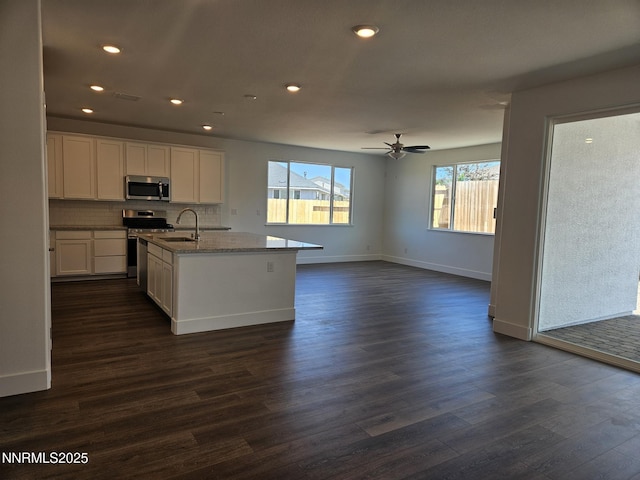 1205 Spur Way, Gardnerville, NV 89410 - kitchen featuring appliances with stainless steel finishes, dark wood-type flooring, white cabinets, light stone counters, and decorative backsplash