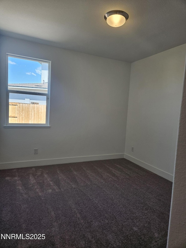 1205 Spur Way, Gardnerville, NV 89410 - unfurnished room featuring dark colored carpet and baseboards