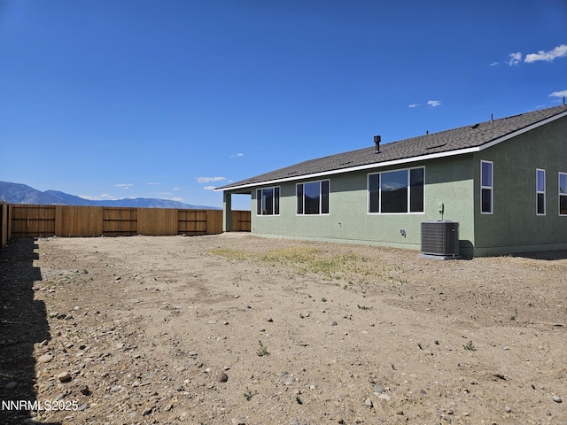 1219 Heybourne Rd, Gardnerville, NV 89410 - rear view of property with a fenced backyard, a mountain view, roof with shingles, and stucco siding