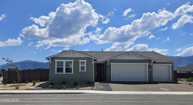 1219 Heybourne Rd, Gardnerville, NV 89410 - ranch-style house featuring a mountain view, driveway, and a garage