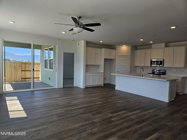 1219 Heybourne Rd, Gardnerville, NV 89410 - kitchen featuring appliances with stainless steel finishes, white cabinetry, dark wood-style floors, and recessed lighting