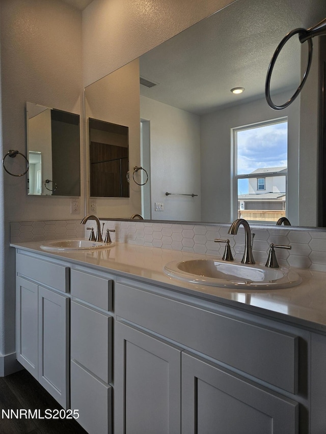 1219 Heybourne Rd, Gardnerville, NV 89410 - bathroom featuring double vanity and decorative backsplash
