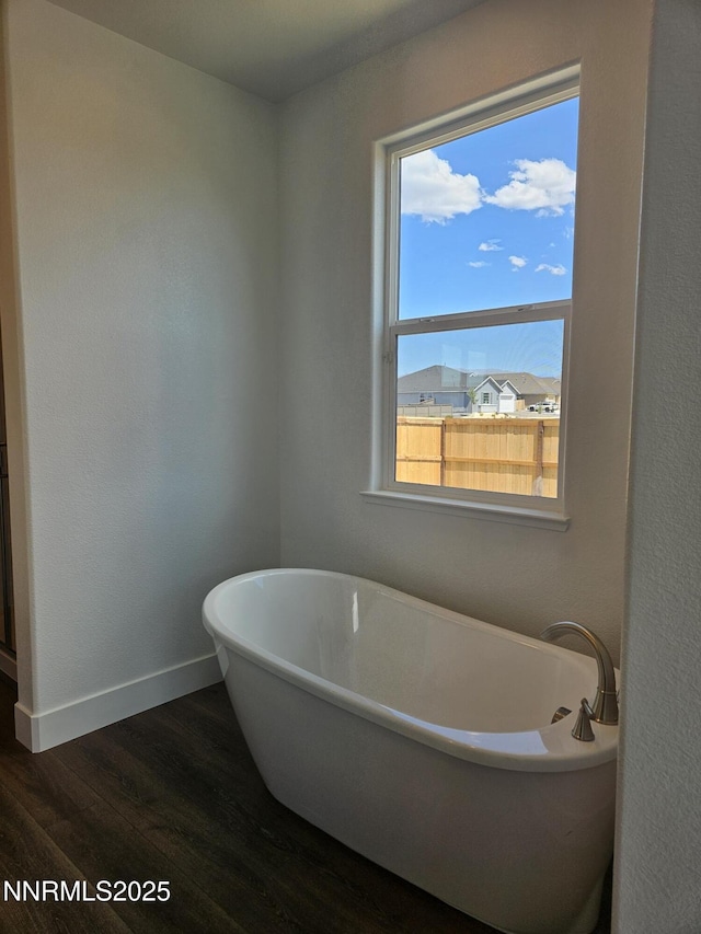 1219 Heybourne Rd, Gardnerville, NV 89410 - full bath featuring wood finished floors and a freestanding tub