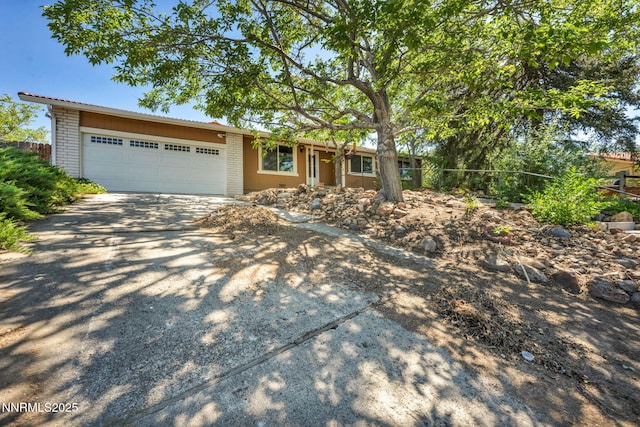 1425 Julie Ct, Reno, NV 89509 - single story home with driveway, a garage, and brick siding