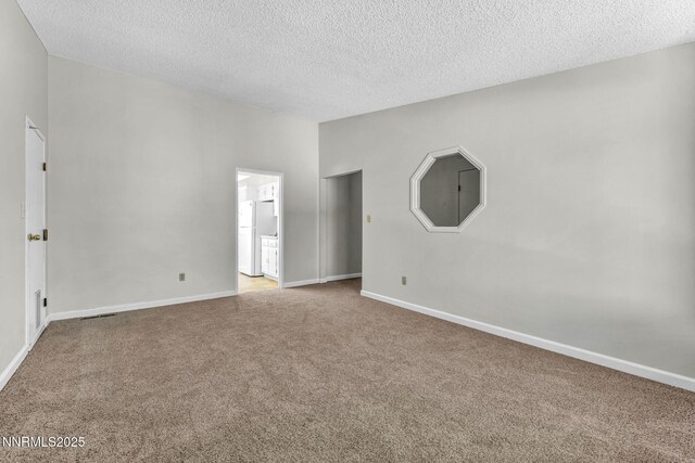 1425 Julie Ct, Reno, NV 89509 - carpeted spare room featuring a textured ceiling and baseboards