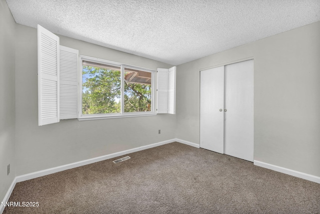 1425 Julie Ct, Reno, NV 89509 - unfurnished bedroom with a textured ceiling, carpet, and a closet
